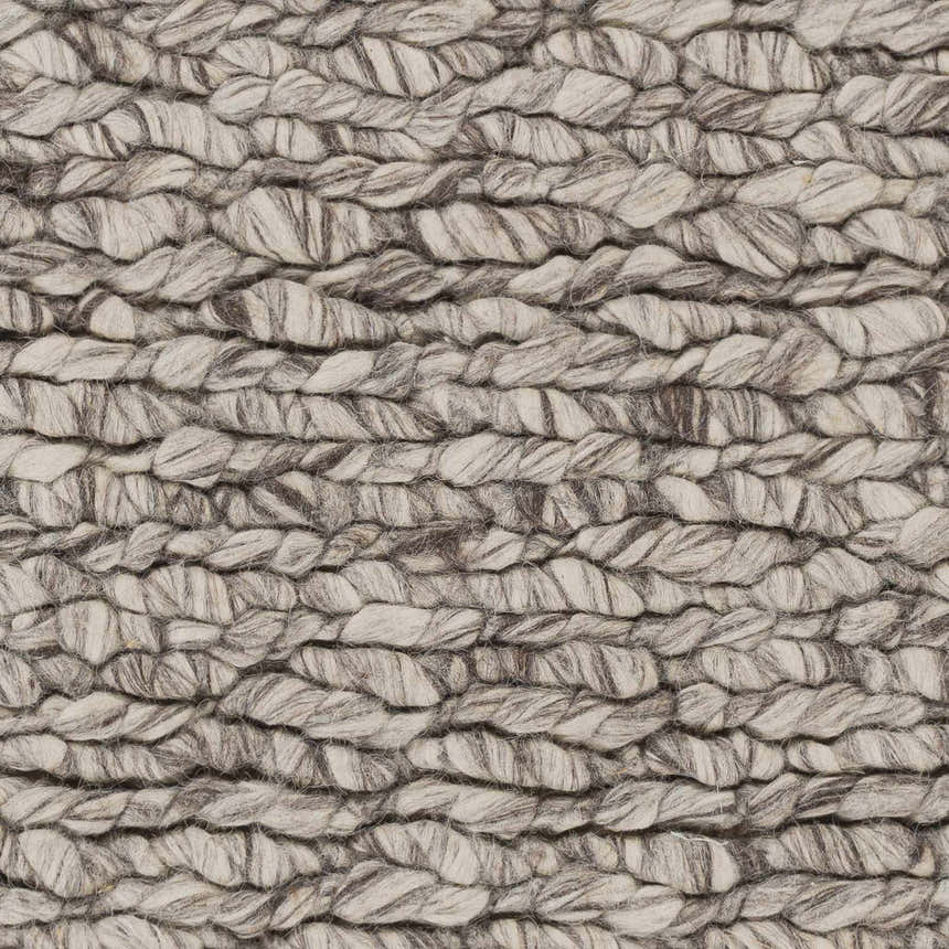 Close-up of the hand woven Rockfield Clearance Rug. Black and cream wool creates a textured, farmhouse style. Swatch