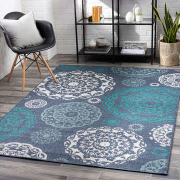 Modern entryway with Reasnor Area Rug in navy, pale blue, teal, and white. Coastal style with chair and bookshelf. Roomscene-Rectangle