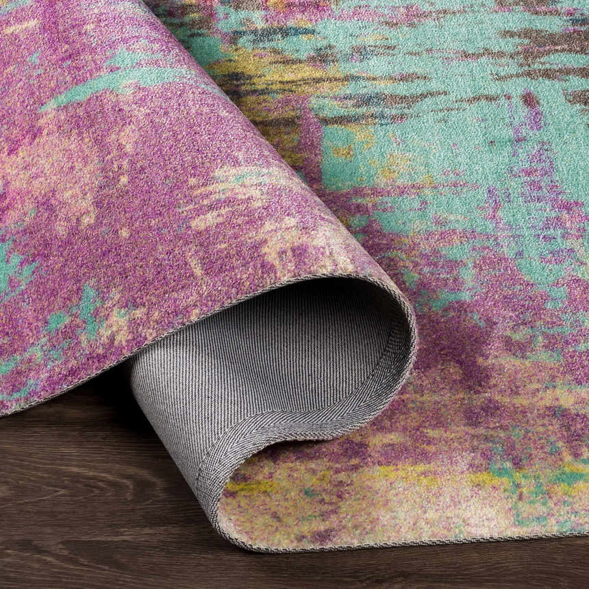 Close-up of the Redland Colorful Abstract Rug showing its aqua, lavender, and magenta hues and machine-woven texture. Fold