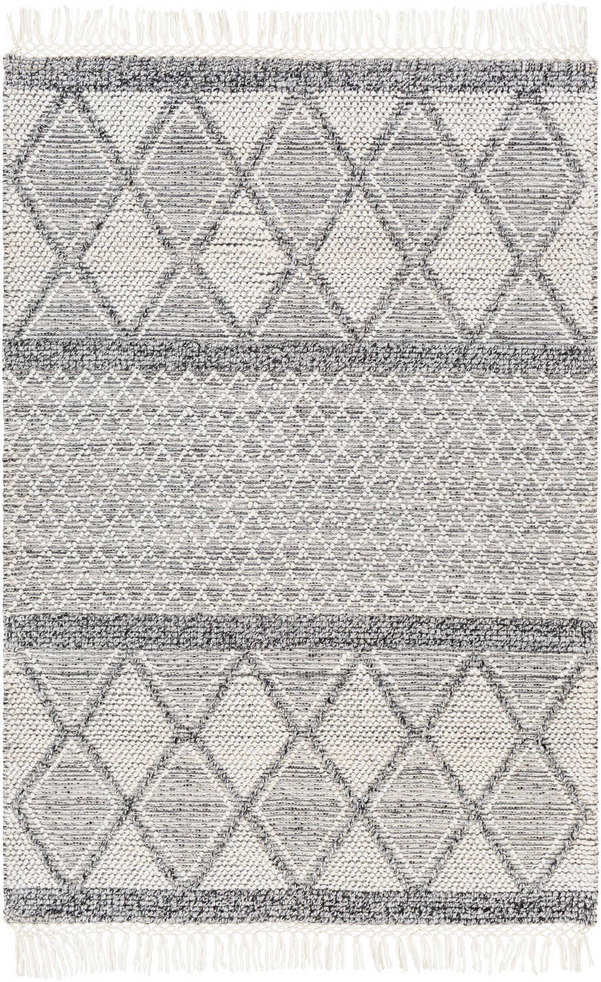 Close-up of the Rehn Area Rug featuring a geometric diamond pattern in dark gray, light gray, and taupe with fringe. Design-Rectangle-576