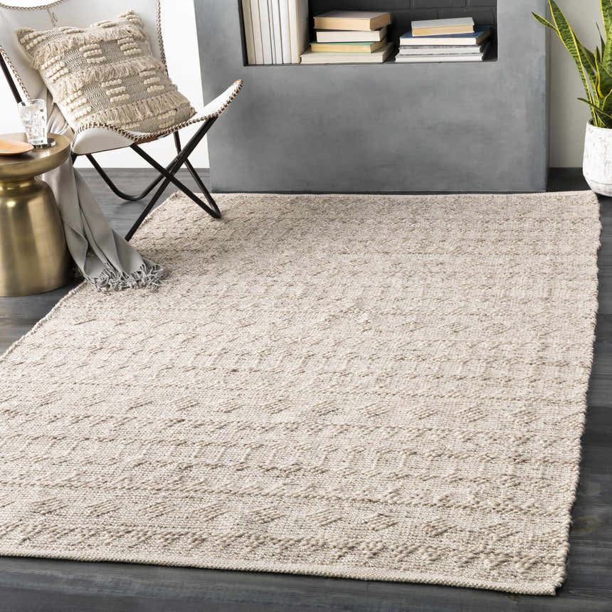 Scandinavian-style room with a metallic silver Argonne Area Rug, white chair, and gold side table. Roomscene-Rectangle