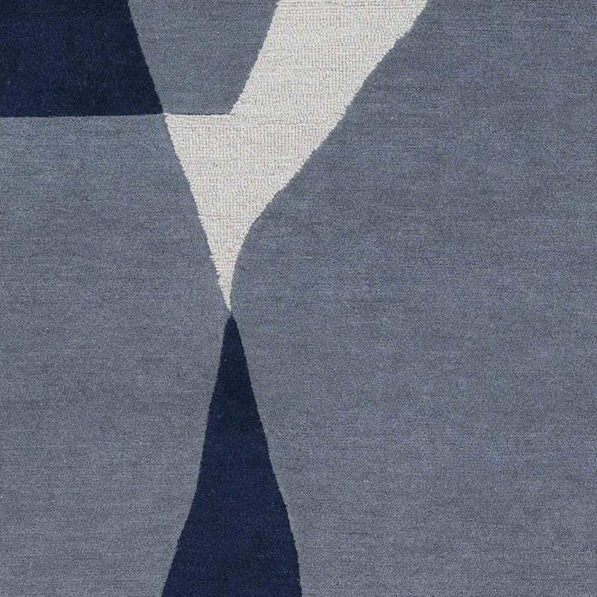 Close-up of the Robbins Modern Blue Wool Rug featuring a geometric design in blue, slate, and white. Swatch