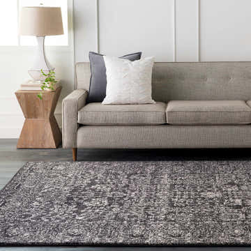 Living room scene with gray sofa and Roseland Area Rug in black, charcoal, and beige. Roomscene-Rectangle
