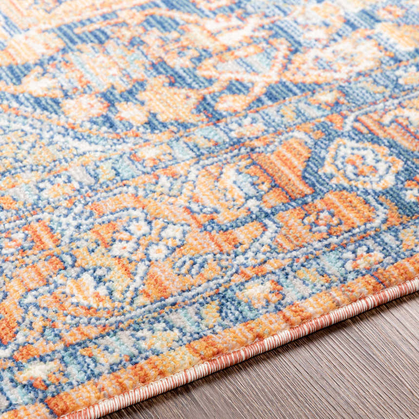 Close up of the Ripponlea Area Rug showing its brick red, navy, and ivory oriental pattern. Texture