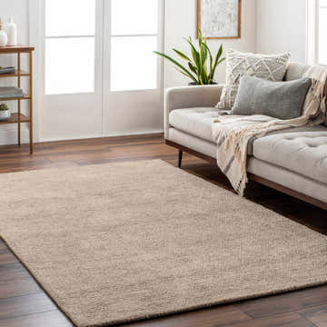 Living room scene with light beige Rosaryville Area Rug, gray sofa, and wood accents. Roomscene-Rectangle