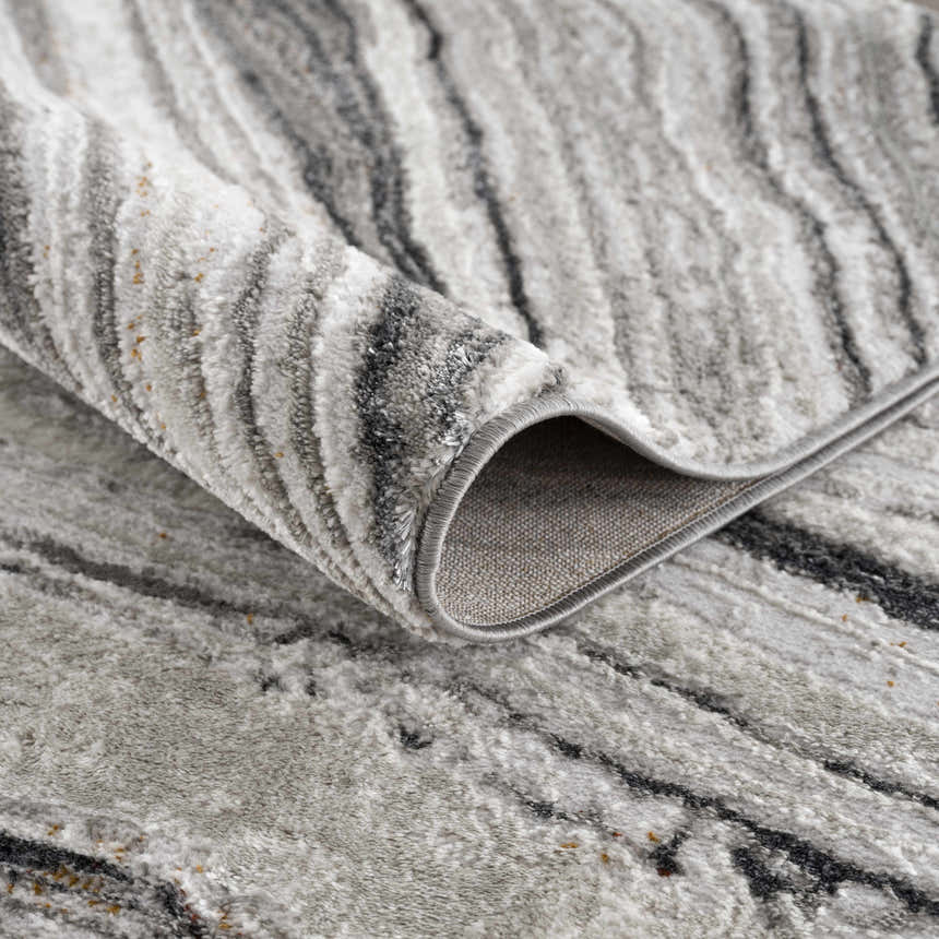Close-up of the Live Marble Dark Gray Area Rug showing its charcoal, gray, and off-white contemporary pattern. Fold