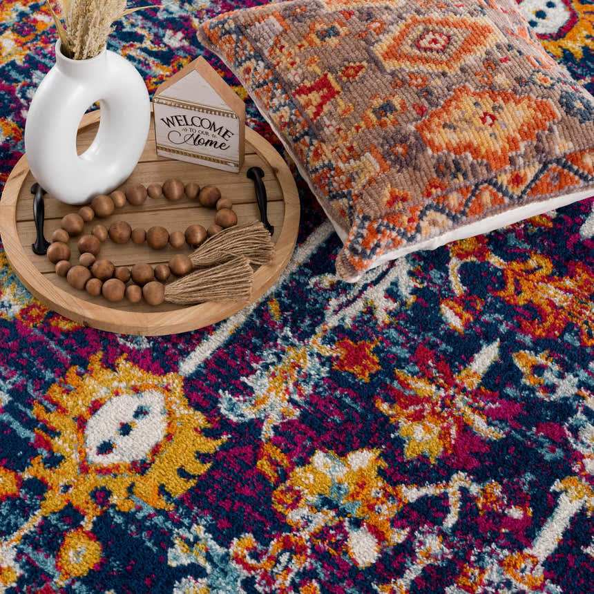 Close-up of the Istanbul Vintage Navy Area Rug, showcasing its navy, ivory, gold, and magenta bohemian pattern and texture. Styleshot