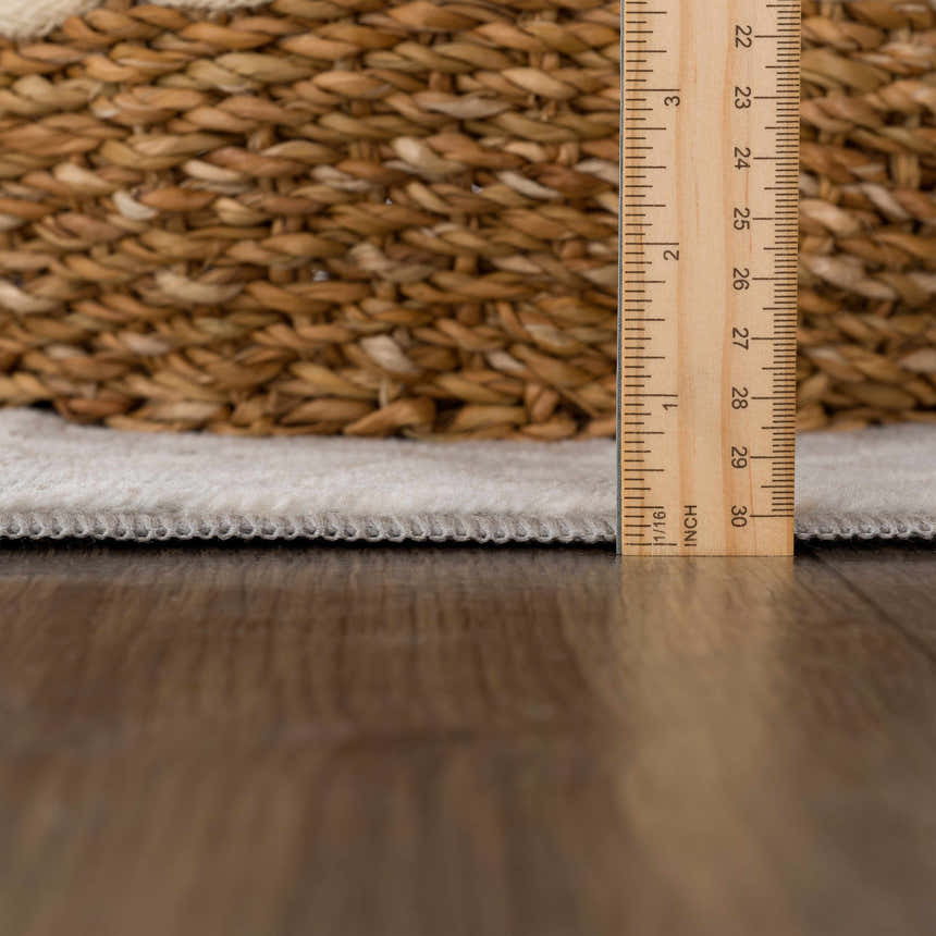 Close-up of Pointblank Tan Leopard Print Rug pile height, showing ivory color and machine woven construction. Pile