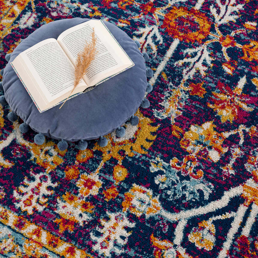 Close-up of the Istanbul Vintage Navy Area Rug showing its bohemian pattern, navy, ivory, yellow, and magenta colors. Styleshot