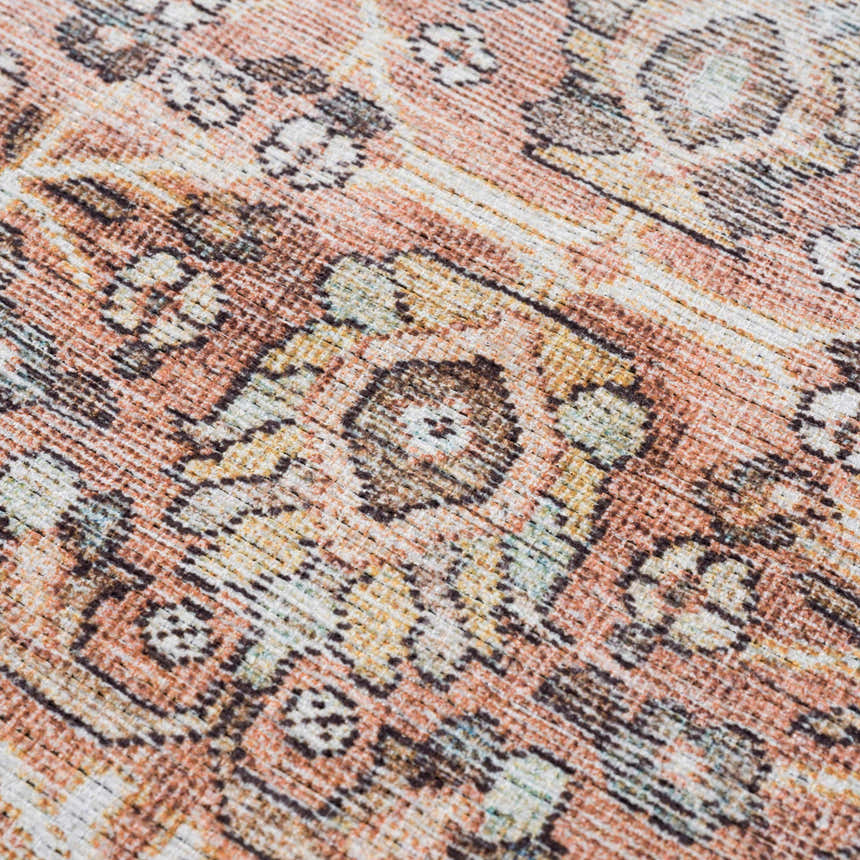 Close-up of Bian Washable Area Rug showing a traditional Persian pattern in peach, brown, and off-white hues. Texture