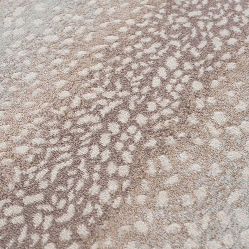 Close-up of the Pointblank Tan Leopard Print Rug, showing its gray, ivory, and tan animal print pattern and soft texture. Texture