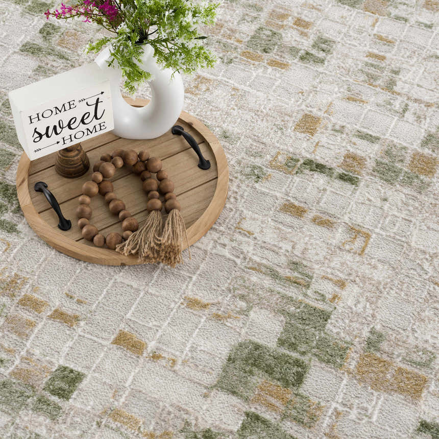 Close up of the Liveri Green Mosaic Rug showing its abstract, geometric pattern and soft, textured weave. Styleshot