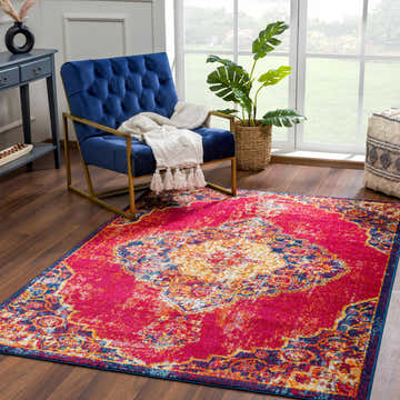 Living room scene with a vibrant Istanbul Red Area Rug, blue chair, and natural light from a large window. Roomscene-Rectangle