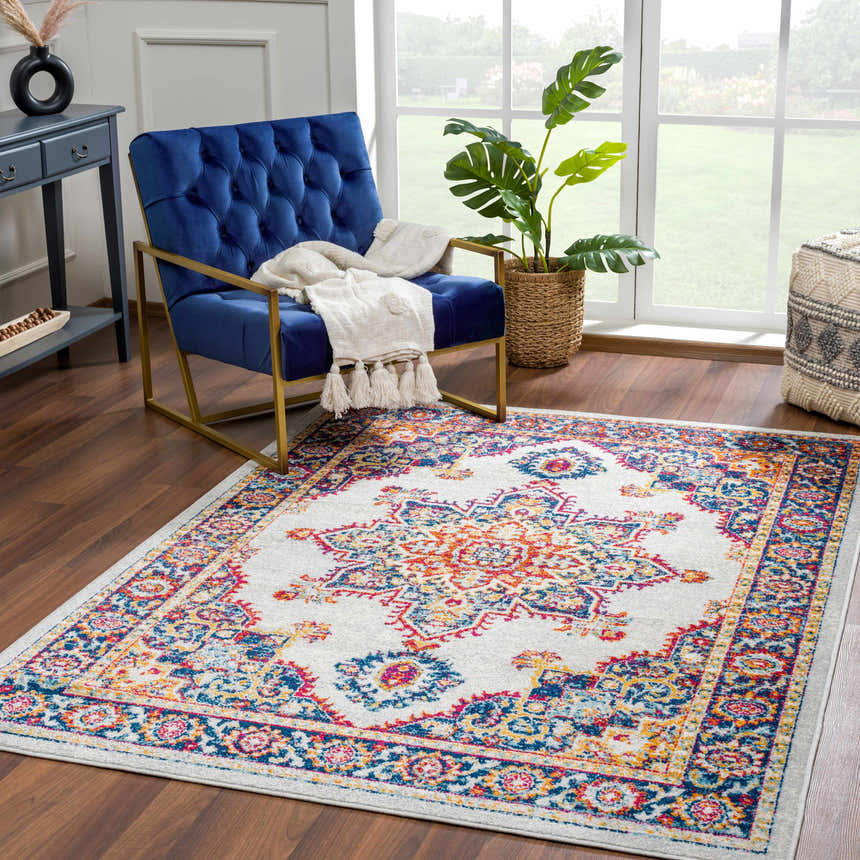 Living room scene with a blue velvet chair and the Istanbul Medallion Orange Area Rug. Roomscene-Rectangle