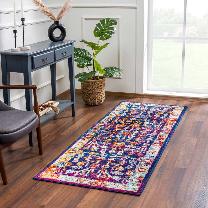 Entryway with Istanbul Vintage Navy Area Rug, blue console table, monstera plant, and wood floors. Roomscene-Runner