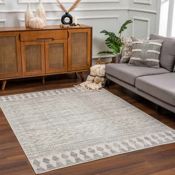Living room scene with a gray sofa and the Chinnor Area Rug in charcoal and light gray. Roomscene-Rectangle