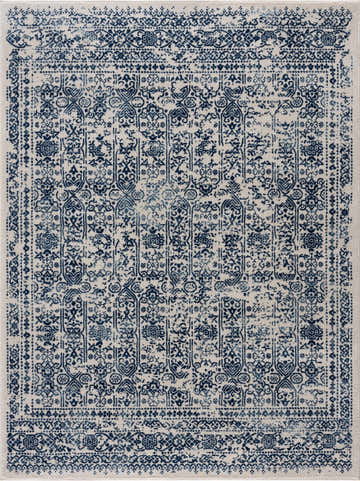 Close-up of the Michie Blue Area Rug featuring a traditional, distressed dark blue and white pattern. Design-Rectangle