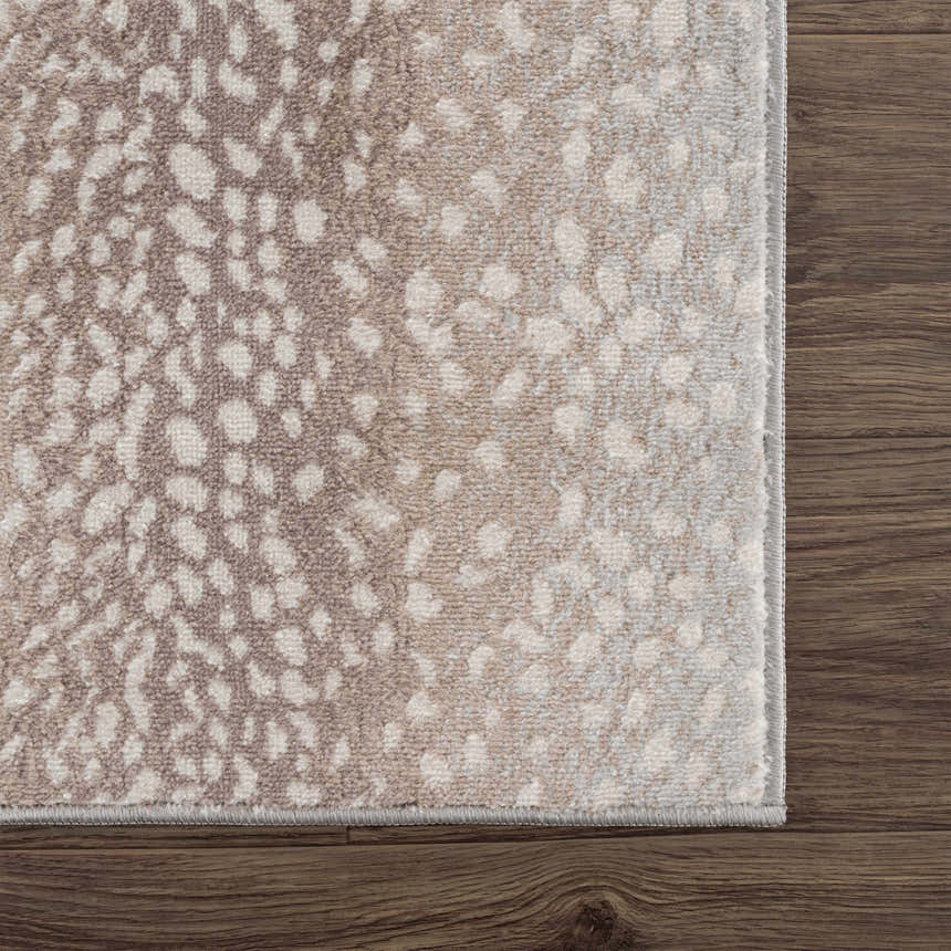 Close-up of the Pointblank Tan Leopard Print Rug showing its ivory and tan animal print design and soft texture. Swatch