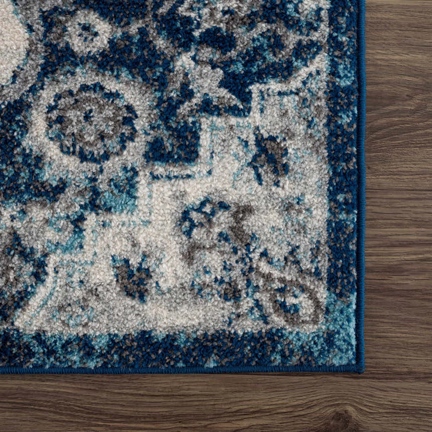 Close-up of the Istanbul Blue Area Rug showing its ivory, navy, and gray Persian-style design and soft texture. Swatch