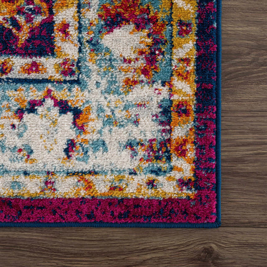 Close-up of the Istanbul Vintage Navy Area Rug showing ivory, navy, gold, and pink floral pattern and soft texture. Swatch