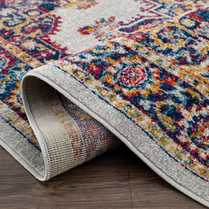 Close-up of the Istanbul Medallion Orange Area Rug, showcasing the ivory, navy, and orange bohemian design and woven texture. Fold