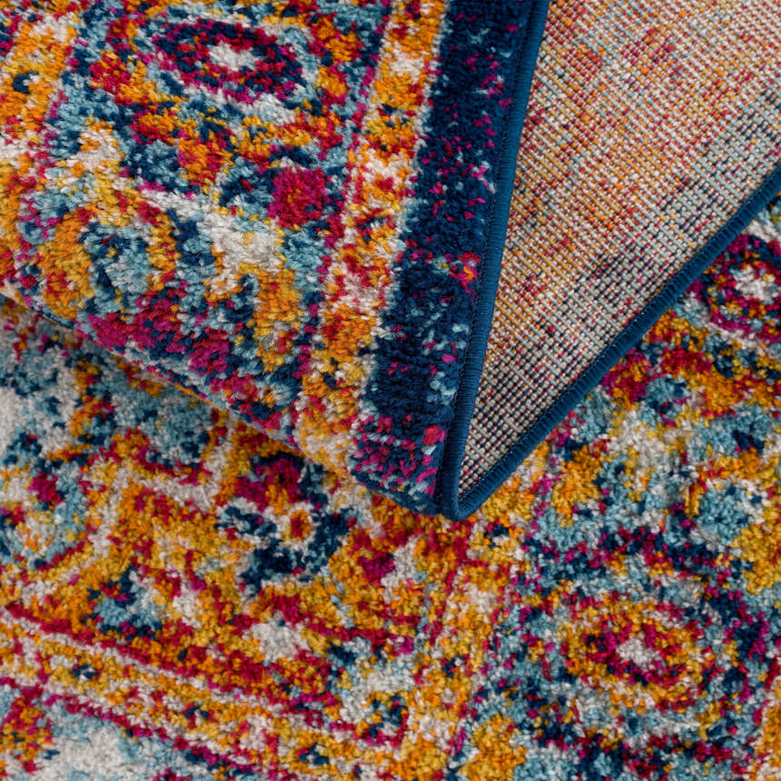 Close-up of the Istanbul Medallion Blue & Orange Area Rug, showing its detailed medallion pattern and vibrant navy, turquoise, and orange colors. Fold