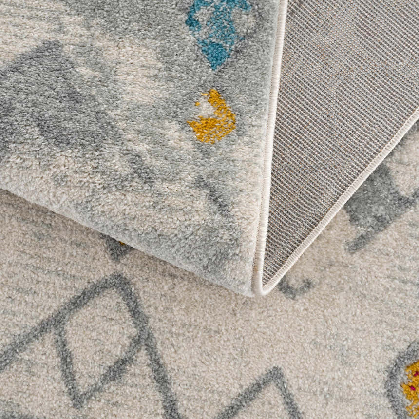 Close-up of the Istanbul Aztec Area Rug showing the texture, colors, and backing. Southwestern style. Fold