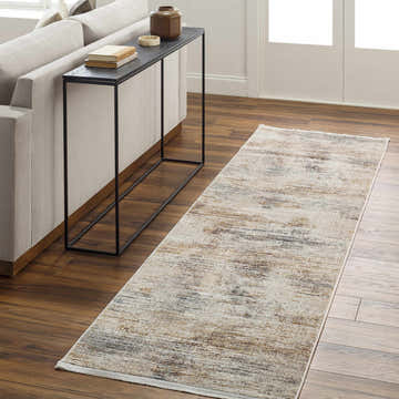 Hallway scene with a beige Carol Luxe Rug with Fringes, sofa, and black console table on wood floor. Roomscene-Runner