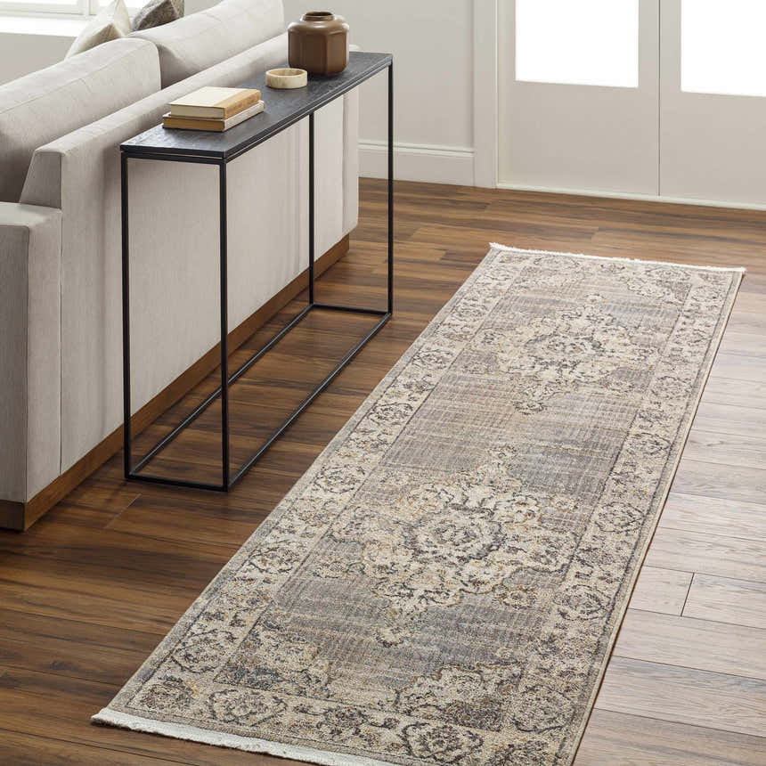 Hallway scene with a Cream Brown Zola Area Rug runner, beige sofa, and dark wood floors. Roomscene-Runner