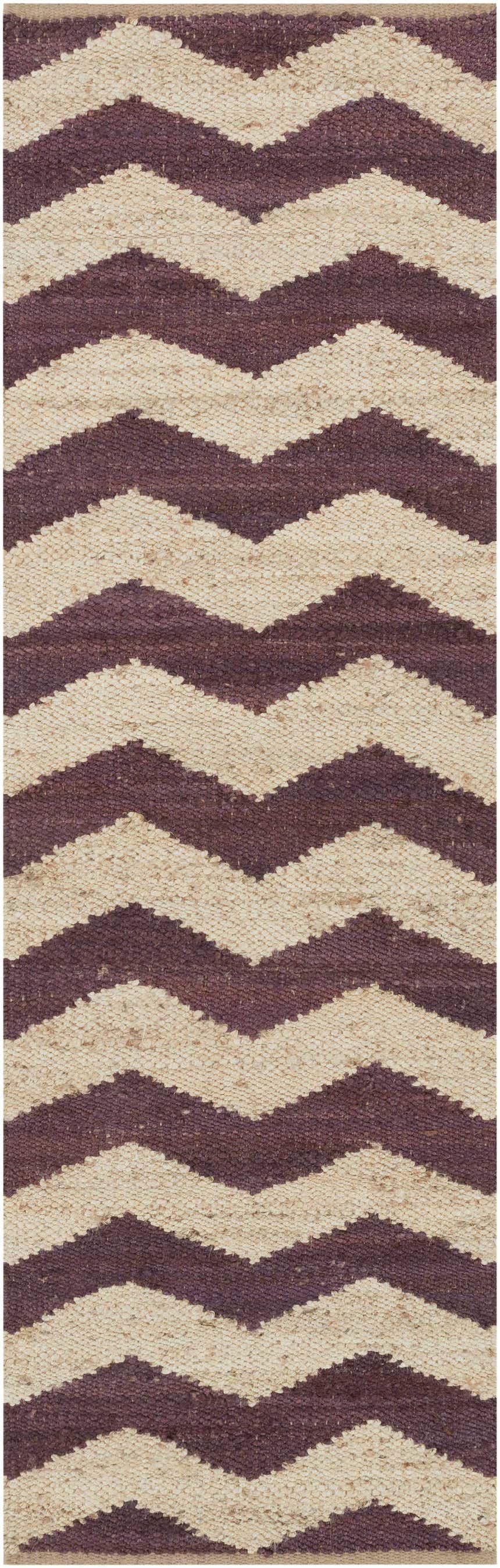 Close-up of the Saginaw Jute Carpet in beige and dark purple. Hand-woven rug with a bold chevron pattern. Design-Runner-38