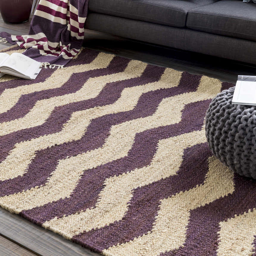 Living room scene with a beige and dark purple Saginaw Jute Carpet, gray sofa, and pouf. Farmhouse style. Roomscene-Rectangle