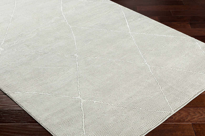 Close-up of the Aldis Grey Plush Textured Washable Rug showing its geometric pattern and soft, plush texture. Corner
