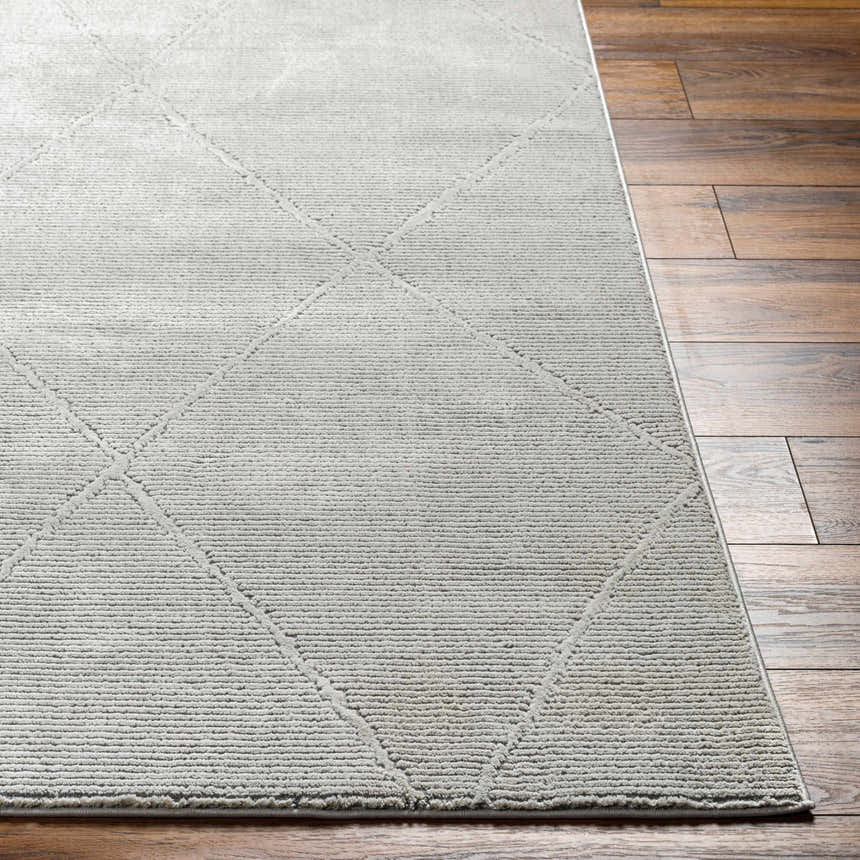 Close-up of the Aldis Grey Plush Textured Washable Rug showing its diamond pattern and soft, plush texture on wood floor. Front