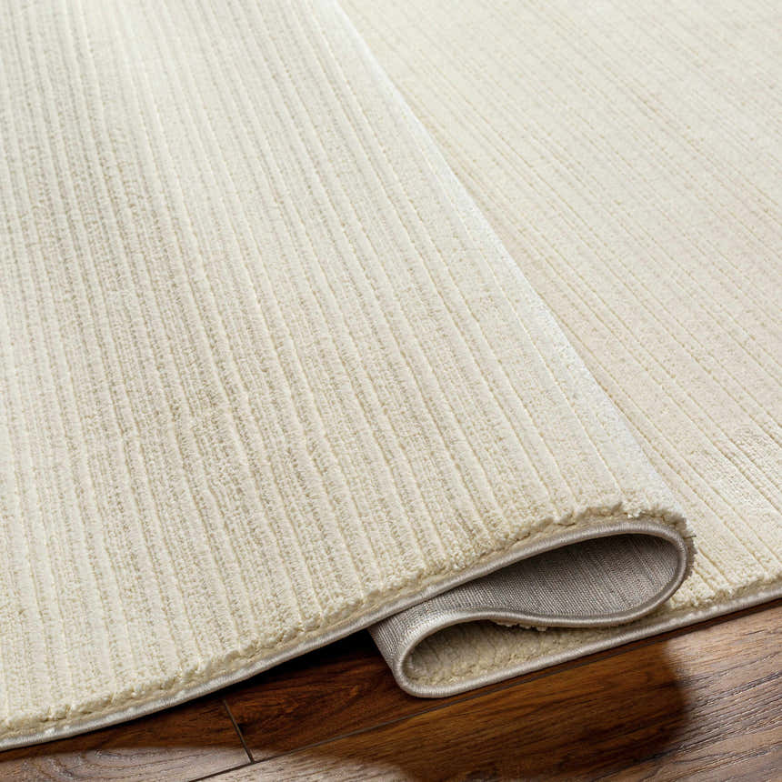Close-up of a Lambswool Kini Plush Textured Washable Rug showing the plush texture and ribbed design. Fold