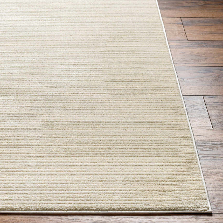 Close-up of the Kini Plush Textured Washable Rug in Lambswool showing its soft texture and subtle horizontal lines. Front