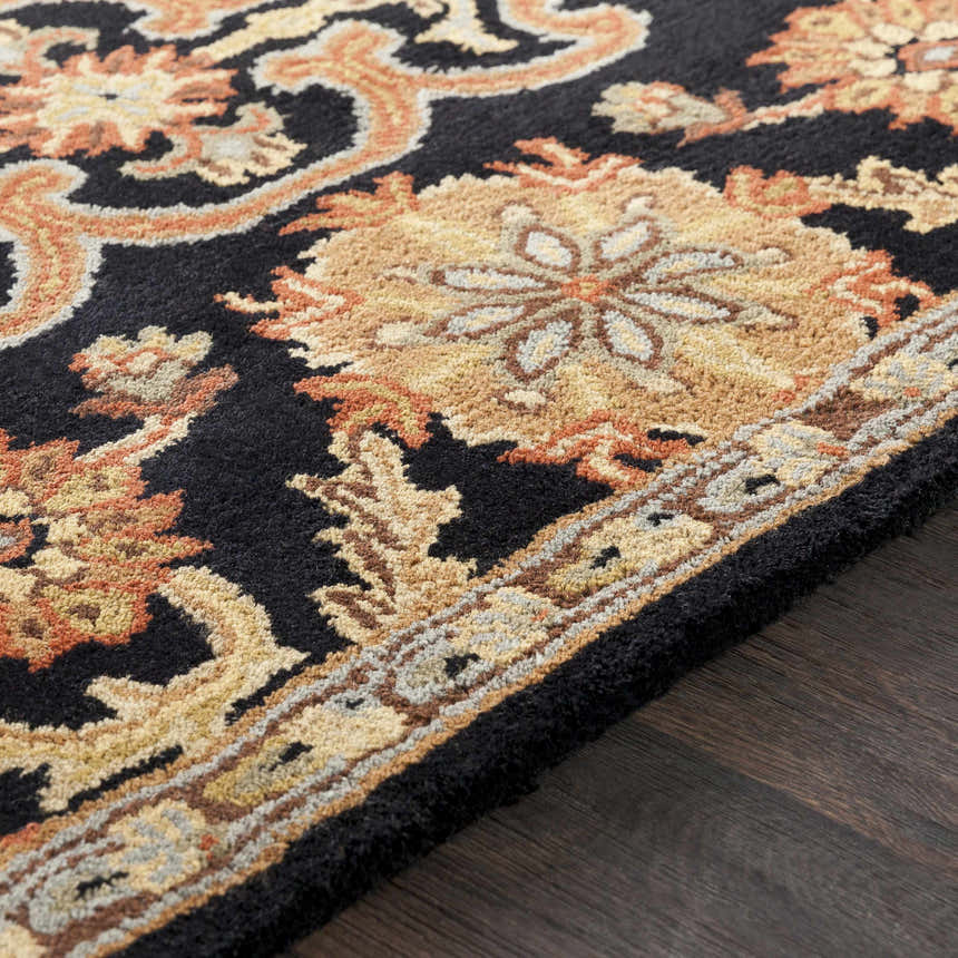 Close up of the hand tufted Salix Black Wool Rug showing the floral pattern and texture. Texture