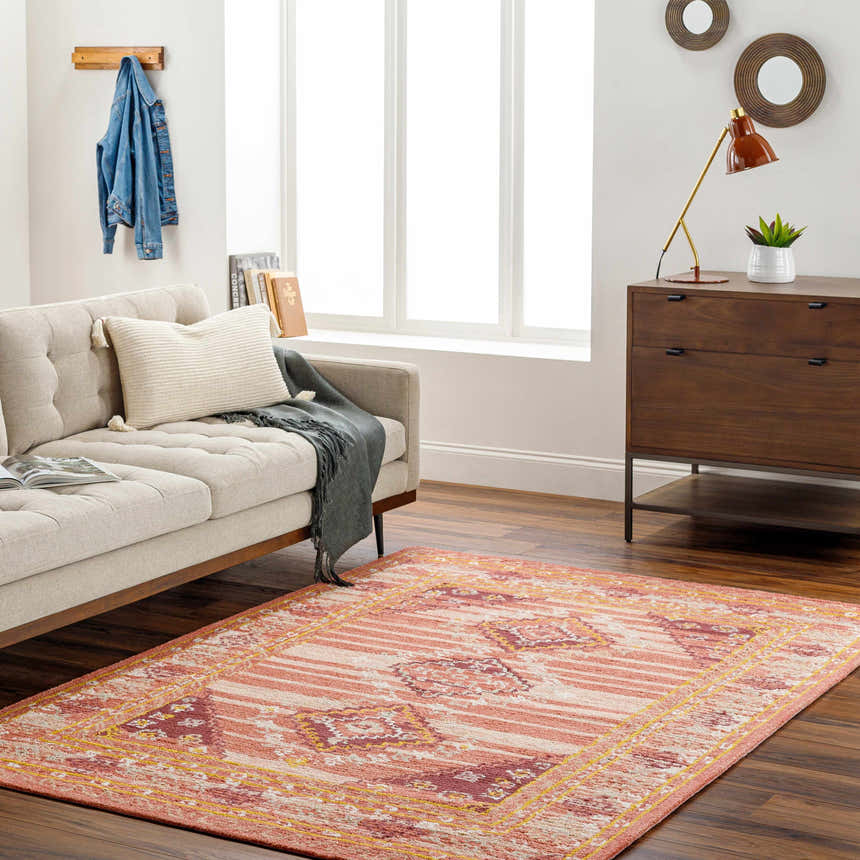 Living room scene with Alena Peach Wool Blend Area Rug, beige sofa, and mid-century modern wood dresser. Roomscene-Rectangle