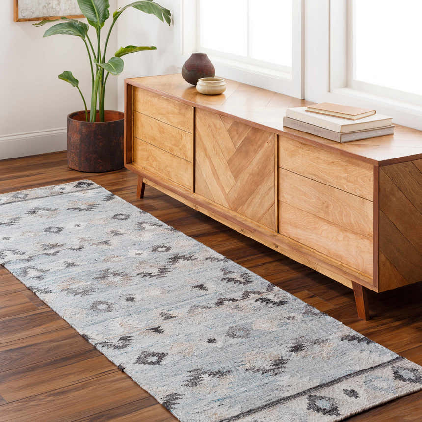 Entryway with light wood console table, plant, and blue Denna Area Rug runner with Southwestern pattern. Roomscene-Runner