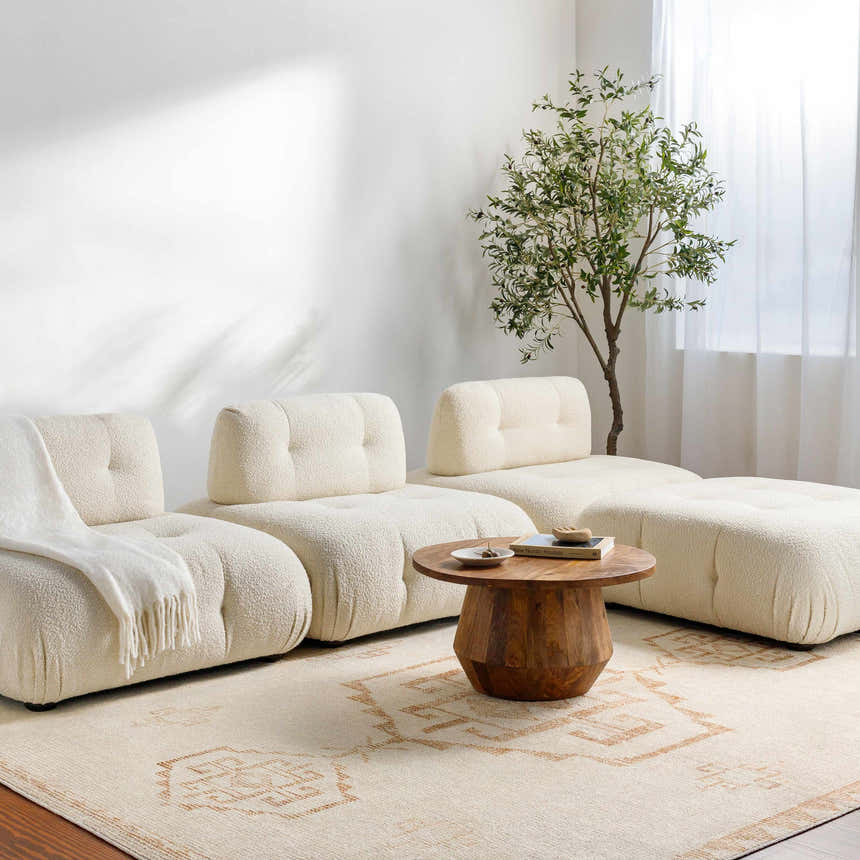 Living room with a modular cream sofa, wood table, and Solona Medallion Dusty Pink rug. Neutral, cozy aesthetic. Roomscene-Rectangle