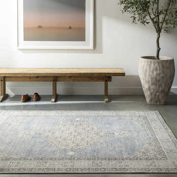 Entryway with wood bench, potted tree, and Lila Medallion Denim Area Rug in charcoal, dark gray, and light gray. Roomscene-Rectangle