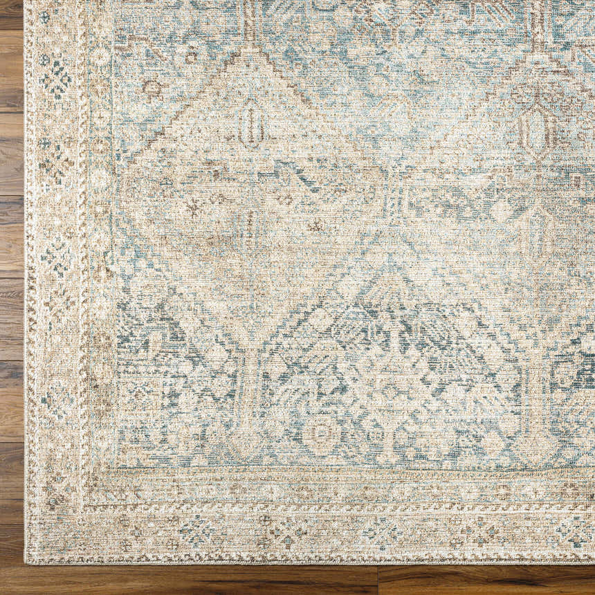 Close-up of Marlene Medallion Beige & Blue Area Rug showing traditional pattern and soft texture on wood floor. Corner