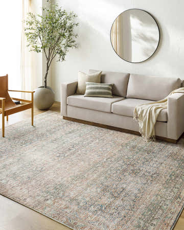 Living room scene with a Marlene Damask Beige & Green Area Rug, neutral sofa, leather chair, and olive tree. Roomscene-Rectangle