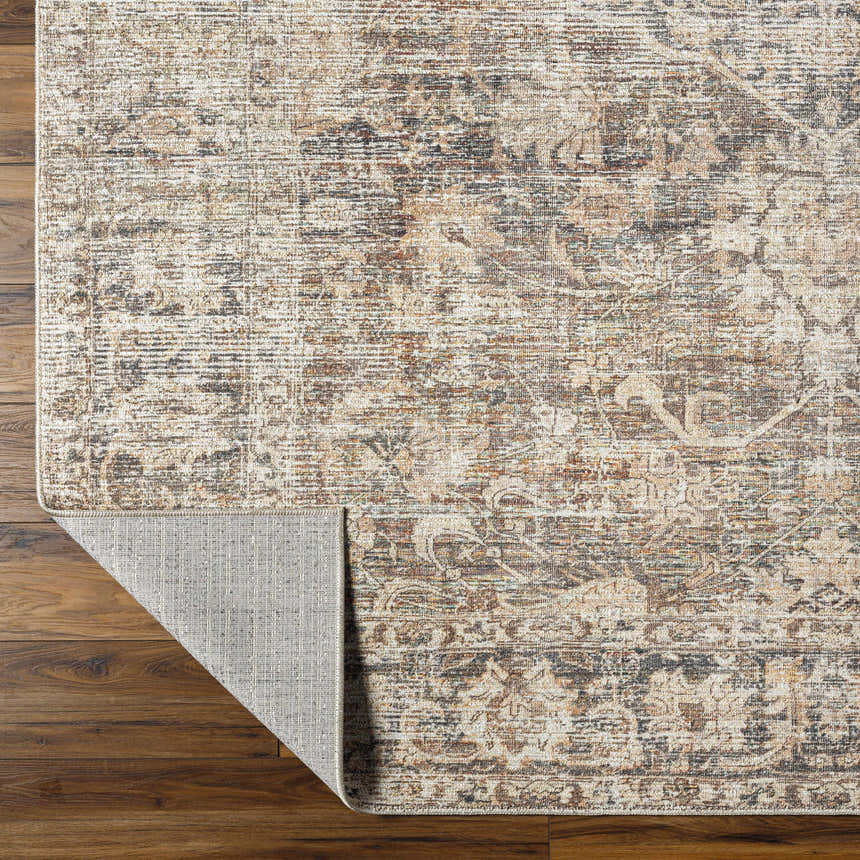 Close-up of the Marlene Medallion Brown Area Rug. Farmhouse style rug with beige, brown, and black medallion pattern. Fold
