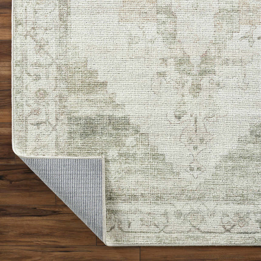 Close-up of the Luca Medallion Olive Area Rug showing its beige, olive, and brown traditional medallion pattern and woven texture. Fold