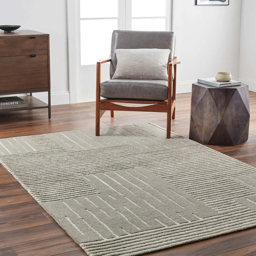 Living room scene with a gray Akuji Area Rug, wood chair, side table, and modern dresser. Roomscene-Rectangle