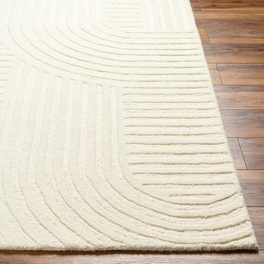 Close-up of the Whan Off White Area Rug showing the hand-tufted wool texture and contemporary striped and curved design. Front