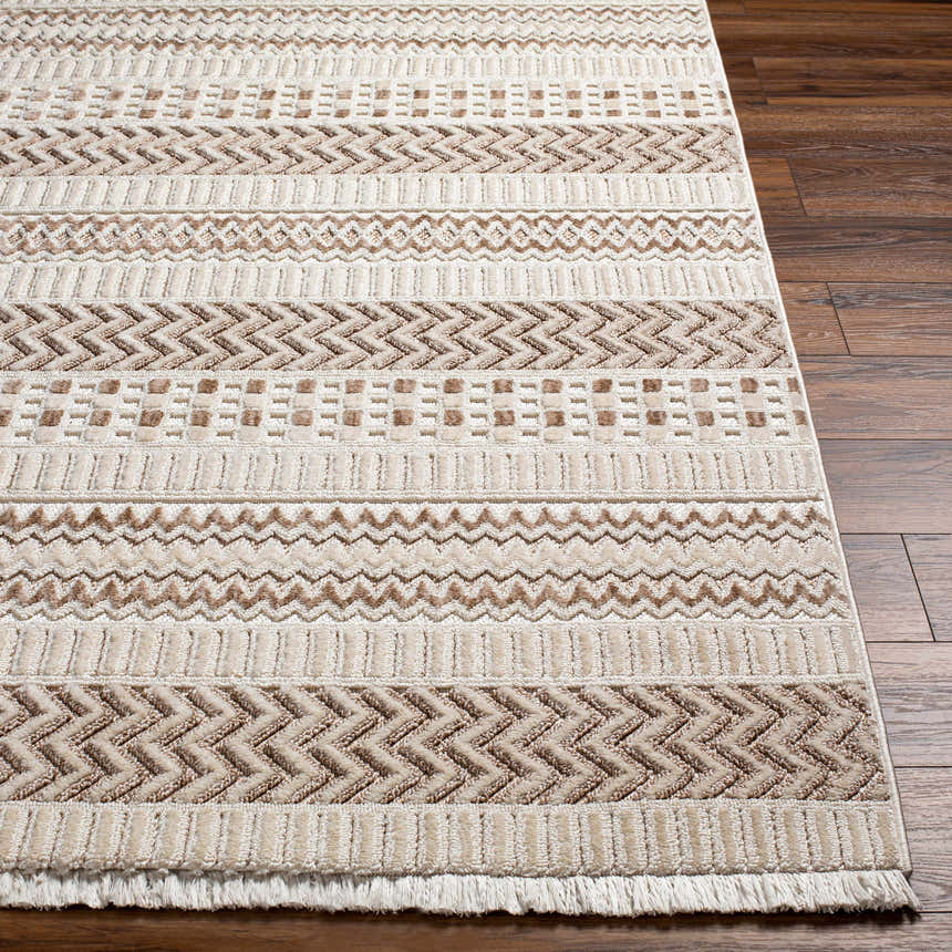 Close-up of the Eiko Beige Textured Saxony Rug, featuring a geometric pattern and decorative fringes. Front