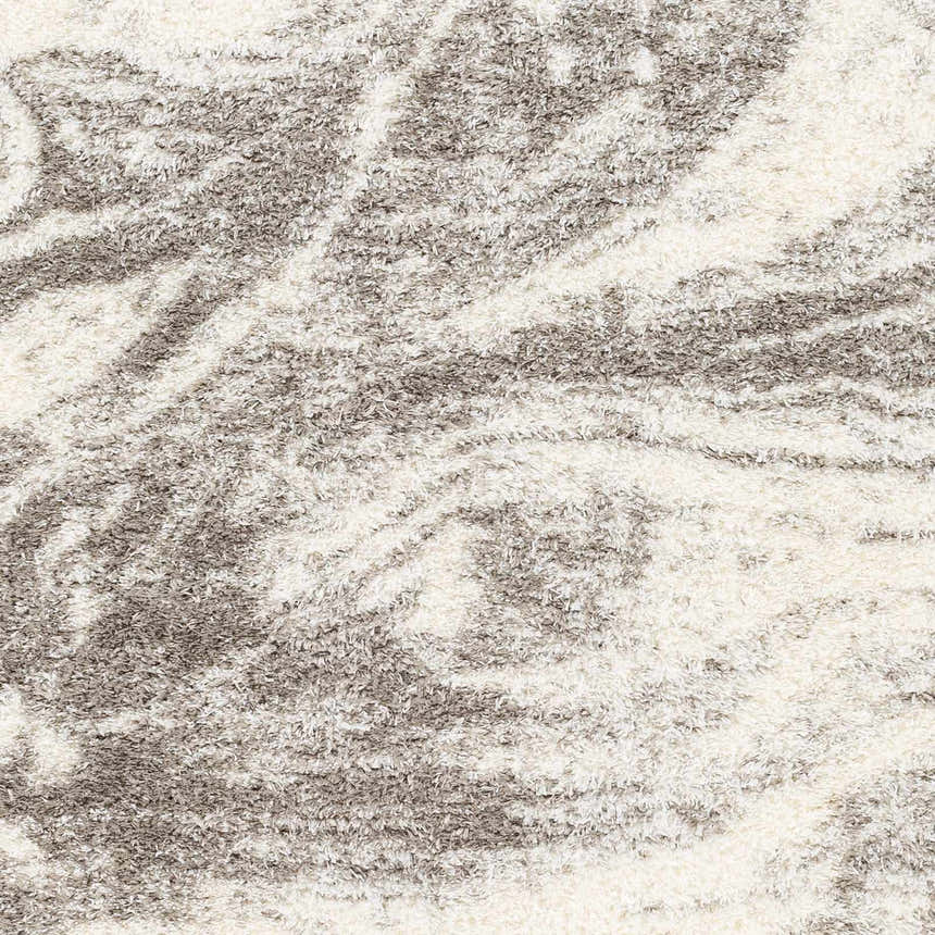 Close-up of the Delma Area Rug showing its shag texture and abstract pattern in cloud gray, dark gray, and off-white. Swatch
