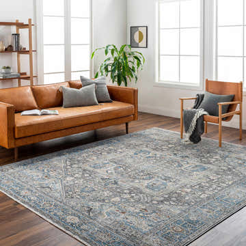 Living room with brown leather sofa and blue Alina Area Rug - Clearance on dark wood floors. Roomscene-Rectangle