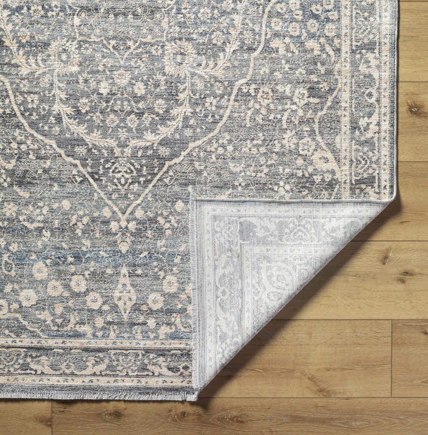 Close-up of the Anouk Area Rug showcasing its dark gray and light gray traditional floral pattern and woven texture. Fold